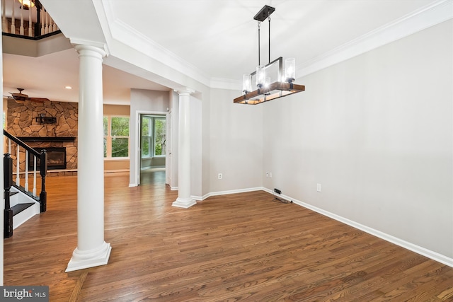 5856 Kittewan Ct, Manassas, VA 20112 - unfurnished dining area with ornate columns, a fireplace, wood finished floors, crown molding, and baseboards