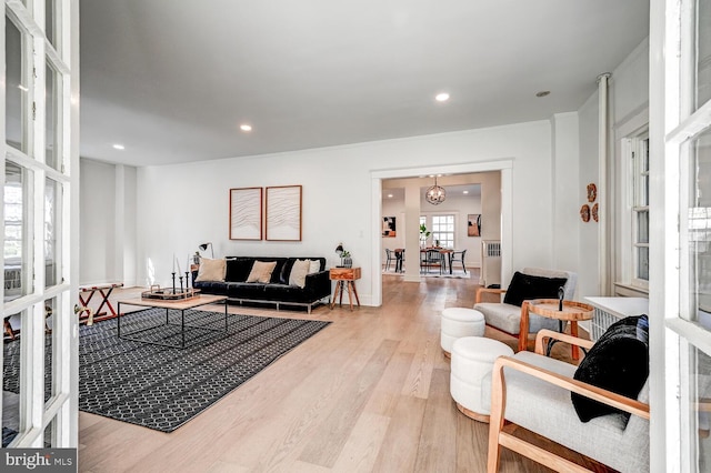 living area featuring french doors, radiator heating unit, light wood finished floors, and recessed lighting