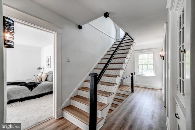 stairs with baseboards and wood finished floors