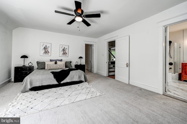 carpeted bedroom featuring ensuite bathroom, baseboards, and a ceiling fan