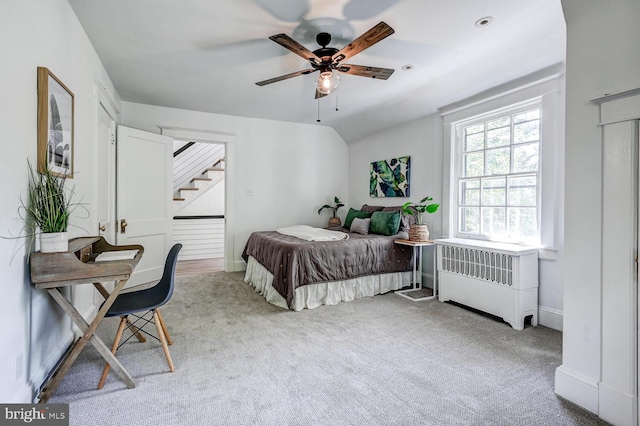 bedroom with baseboards, light colored carpet, vaulted ceiling, and ceiling fan