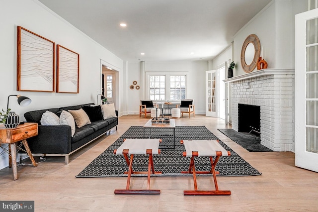 living room featuring recessed lighting, wood finished floors, and a fireplace