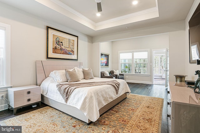 bedroom featuring dark wood-style flooring, recessed lighting, a ceiling fan, ornamental molding, and a raised ceiling