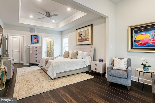 bedroom with dark wood-type flooring, a raised ceiling, visible vents, and ornamental molding