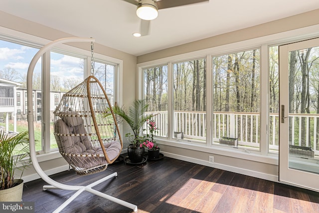 unfurnished sunroom featuring baseboards, wood finished floors, and recessed lighting