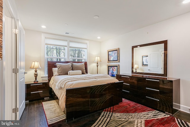 bedroom featuring dark wood finished floors, visible vents, and recessed lighting