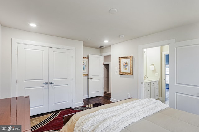 bedroom featuring a sink, dark wood-style flooring, visible vents, recessed lighting, and a closet