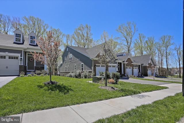 view of front of property with a garage, a front yard, and concrete driveway