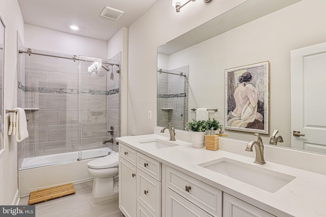 full bath featuring visible vents, toilet, enclosed tub / shower combo, and a sink