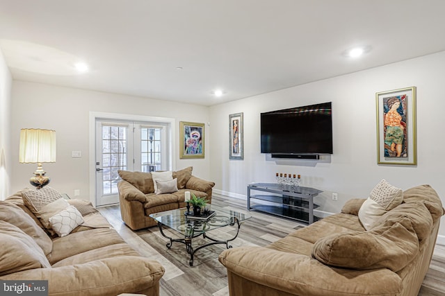 living area with recessed lighting and light wood-style flooring