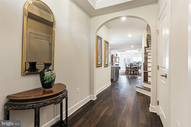 hall with baseboards, arched walkways, dark wood-style floors, and recessed lighting