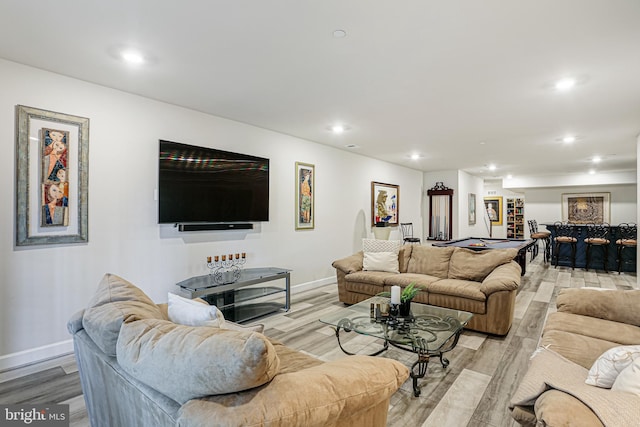 living room with baseboards, recessed lighting, and light wood-style floors