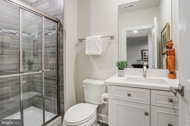 bathroom featuring a shower stall, visible vents, toilet, and vanity