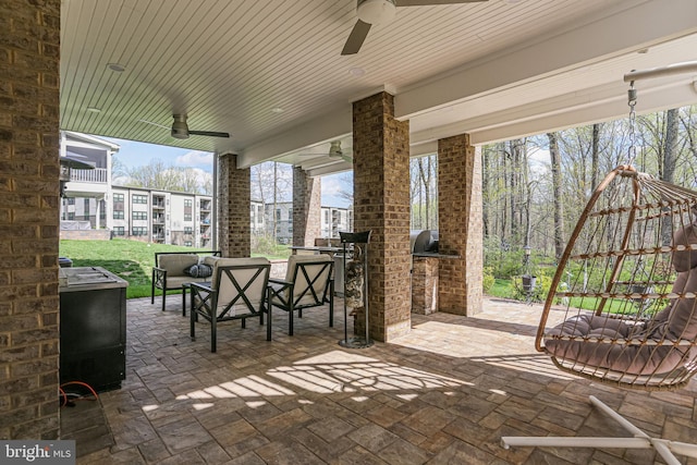 view of patio / terrace featuring ceiling fan, outdoor lounge area, and exterior kitchen