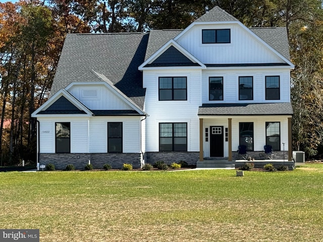 modern farmhouse style home featuring a front lawn, covered porch, and central AC
