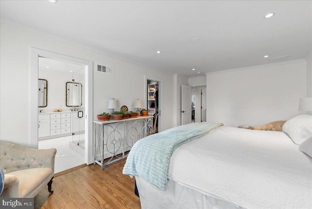 bedroom featuring visible vents, ornamental molding, recessed lighting, and light wood-type flooring