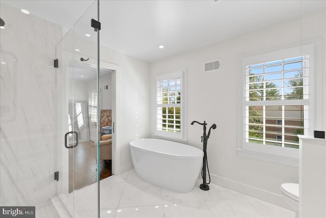 full bathroom featuring visible vents, a freestanding tub, a stall shower, baseboards, and recessed lighting