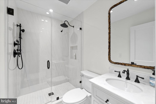 full bath with toilet, visible vents, a marble finish shower, and vanity