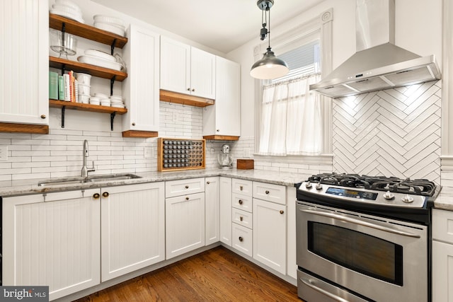 4916 40th Pl, Hyattsville, MD 20781 - kitchen featuring stainless steel range with gas stovetop, wall chimney range hood, a sink, tasteful backsplash, and white cabinetry