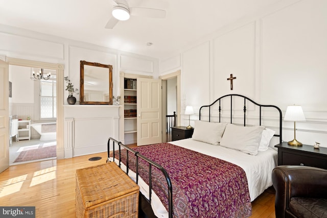 4916 40th Pl, Hyattsville, MD 20781 - bedroom featuring a decorative wall, a chandelier, wood finished floors, and a ceiling fan