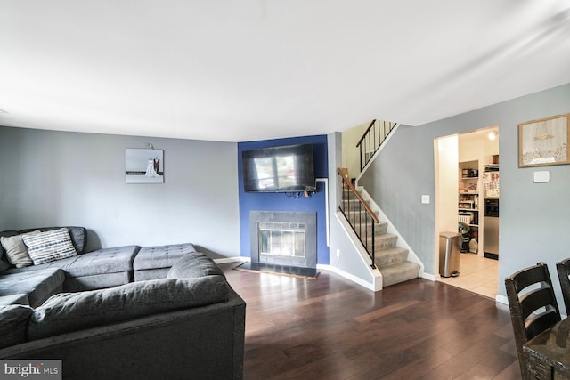 11326 Appledowre Way Unit 154, Germantown, MD 20876 - living room featuring a fireplace with flush hearth, stairs, hardwood / wood-style flooring, and baseboards