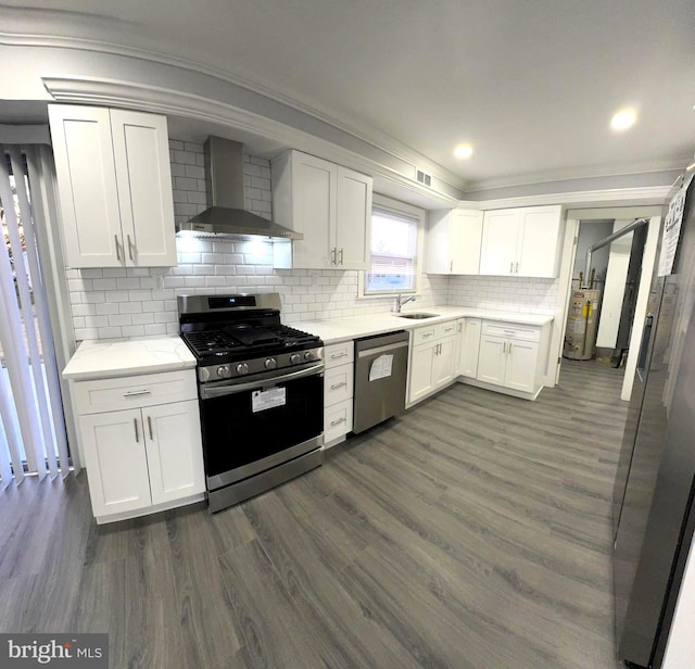 18 Grayson Cir, Willingboro, NJ 08046 - kitchen featuring stainless steel appliances, gas water heater, a sink, white cabinetry, and wall chimney exhaust hood