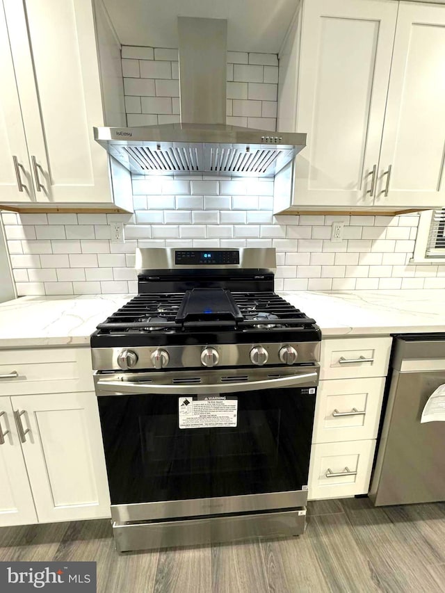 18 Grayson Cir, Willingboro, NJ 08046 - kitchen featuring appliances with stainless steel finishes, wall chimney range hood, light stone countertops, and backsplash