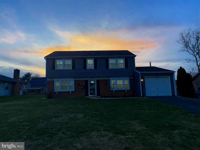 18 Grayson Cir, Willingboro, NJ 08046 - view of front of house with driveway, a yard, brick siding, and an attached garage
