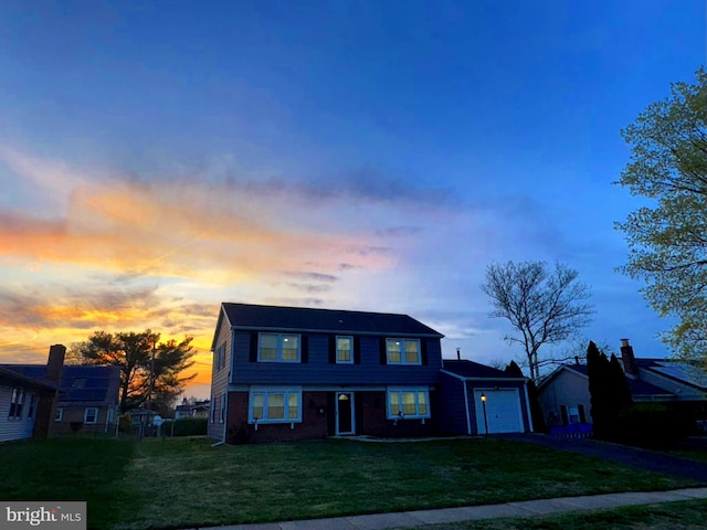 18 Grayson Cir, Willingboro, NJ 08046 - traditional-style house featuring a front yard, aphalt driveway, brick siding, and an attached garage