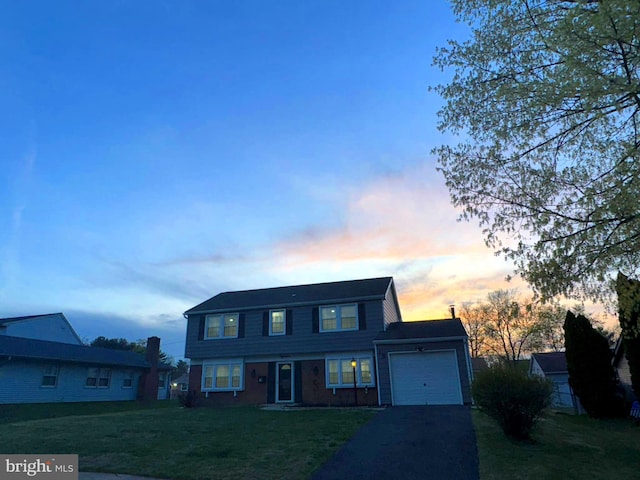 18 Grayson Cir, Willingboro, NJ 08046 - traditional-style home featuring a front lawn, a garage, brick siding, and aphalt driveway