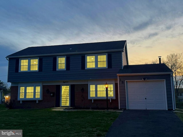 18 Grayson Cir, Willingboro, NJ 08046 - colonial-style house with a yard, aphalt driveway, brick siding, and a garage