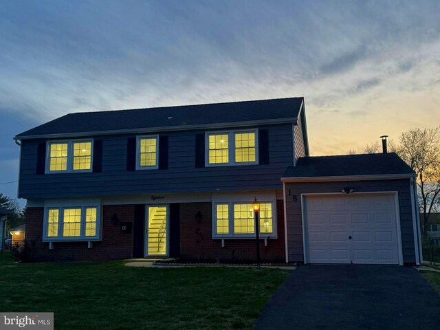 18 Grayson Cir, Willingboro, NJ 08046 - colonial-style house with a yard, aphalt driveway, brick siding, and a garage