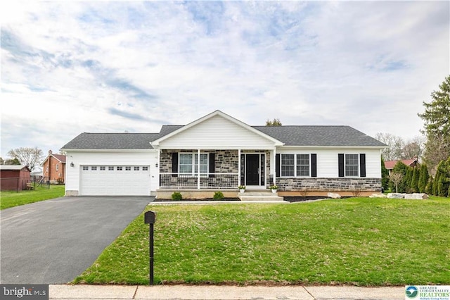 single story home with driveway, a front yard, covered porch, and a garage