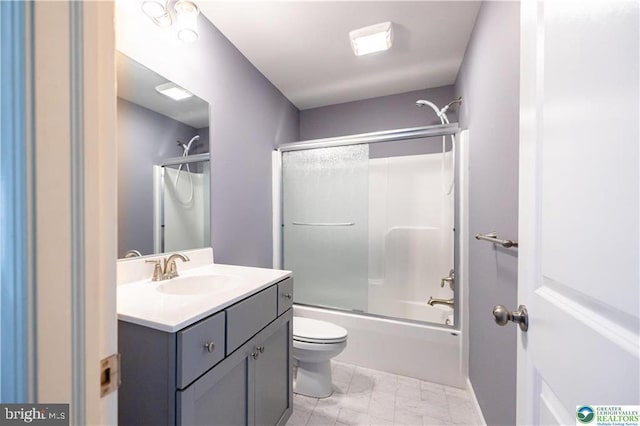 bathroom with bath / shower combo with glass door, vanity, marble finish floor, and toilet