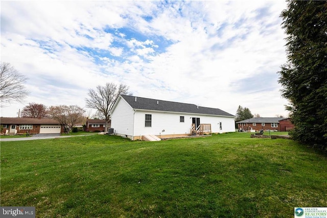 rear view of property with a lawn