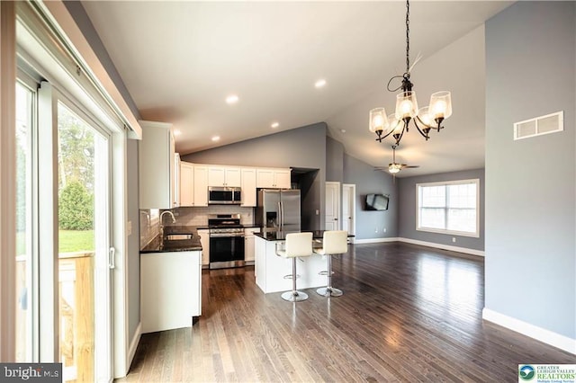 kitchen featuring visible vents, a sink, dark countertops, white cabinetry, and stainless steel appliances