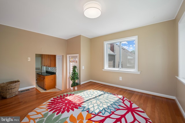 bedroom featuring light wood-type flooring, baseboards, and visible vents