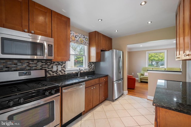 kitchen featuring recessed lighting, plenty of natural light, stainless steel appliances, and a sink
