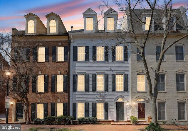 townhome / multi-family property featuring brick siding