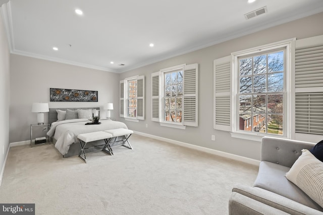 carpeted bedroom with baseboards, crown molding, multiple windows, and visible vents