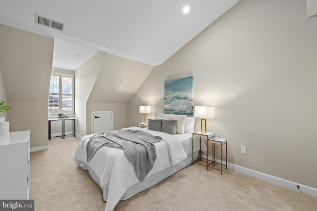 bedroom with vaulted ceiling, baseboards, and light carpet