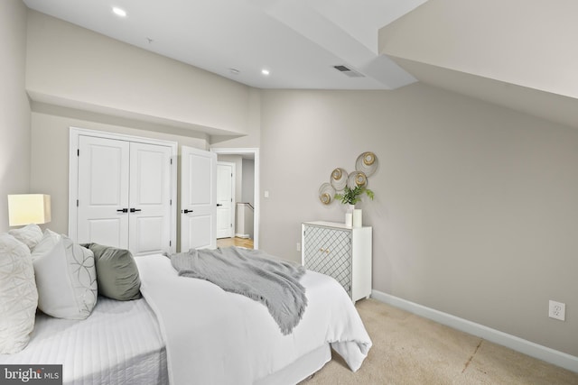 bedroom featuring recessed lighting, vaulted ceiling, a closet, baseboards, and light colored carpet