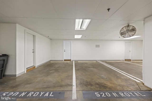 parking garage featuring baseboards