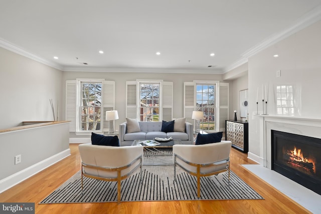 living room with a glass covered fireplace, baseboards, wood finished floors, and recessed lighting