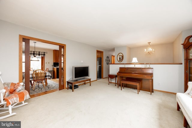 living room with baseboards and a chandelier