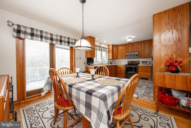 dining area with light wood-style flooring