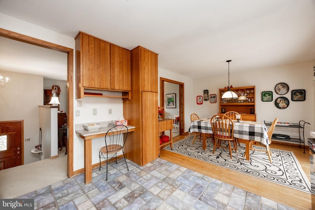 dining space with light wood-type flooring and a chandelier