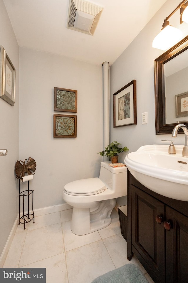 bathroom featuring tile patterned flooring, visible vents, toilet, and vanity