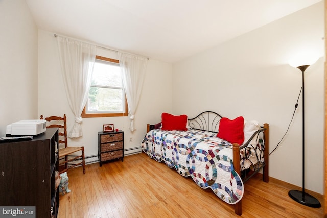 bedroom featuring wood-type flooring and baseboard heating