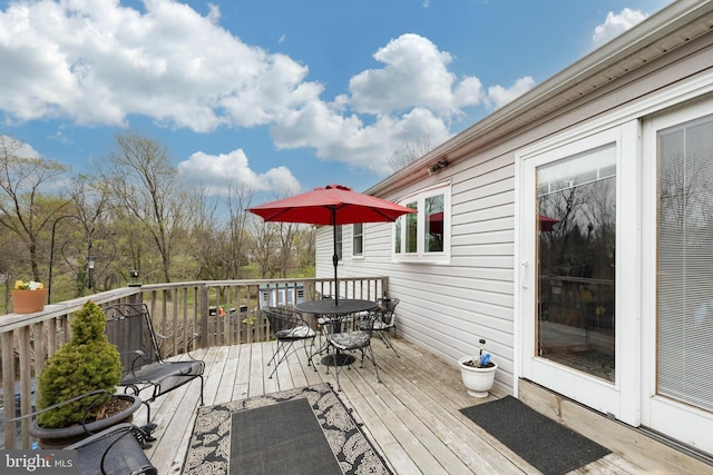 wooden terrace with outdoor dining area